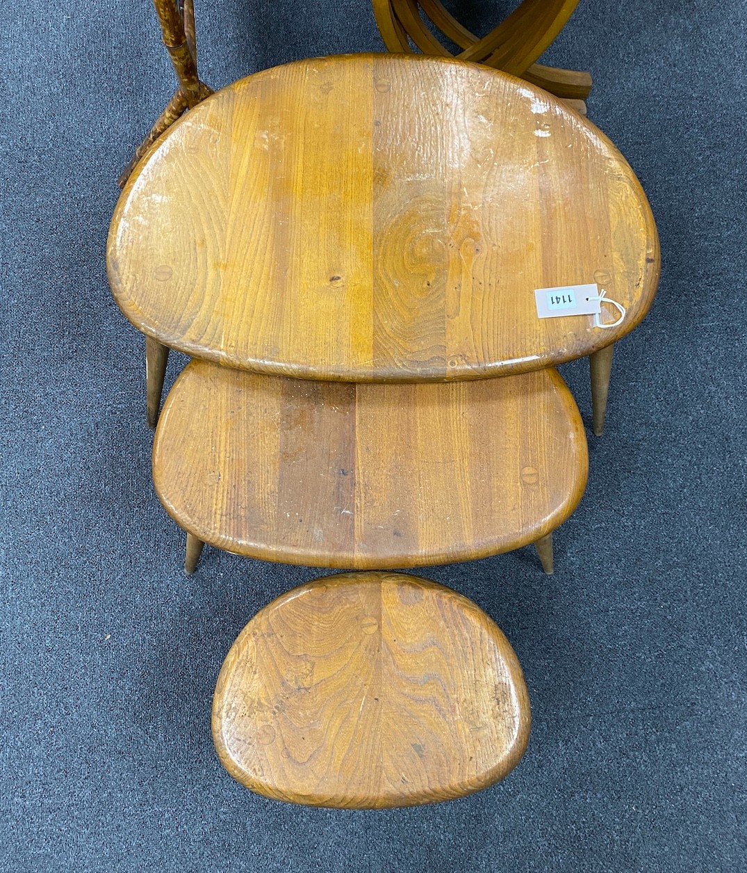 A nest of three Ercol light elm and beech 'pebble' tables, width 65cm, depth 42cm, height 40cm